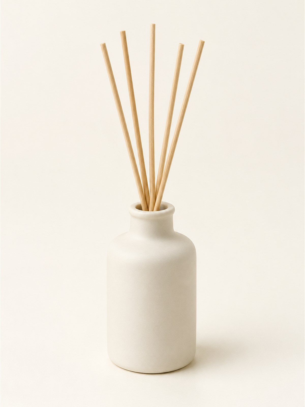 Wood-fired stoneware cup with ash glaze on a linen cloth