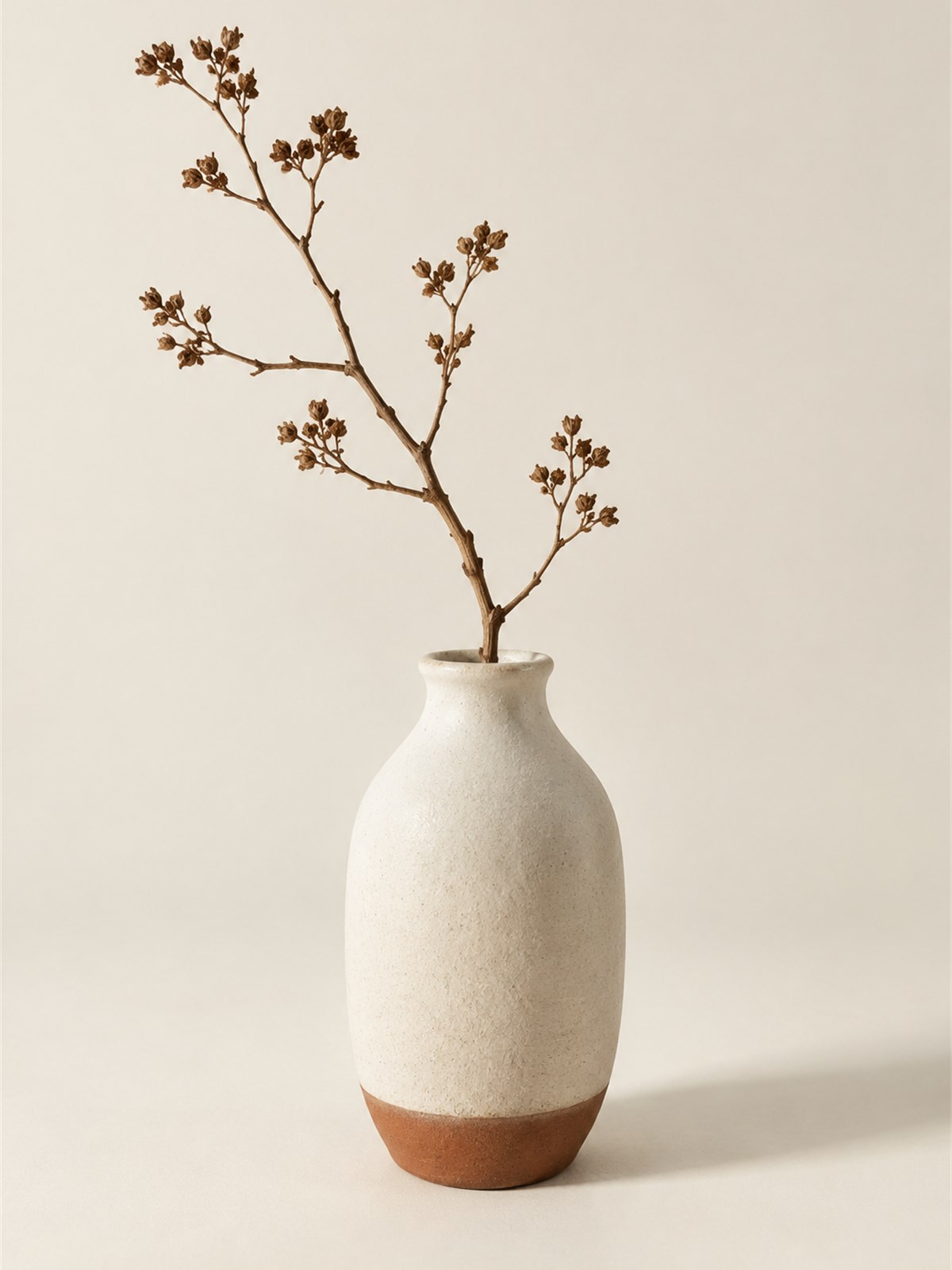 Celadon glazed stoneware vase with a single branch